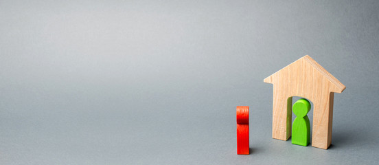 A wooden figure of a man meets a guest. The concept of an apartment house, real estate. Buying and...