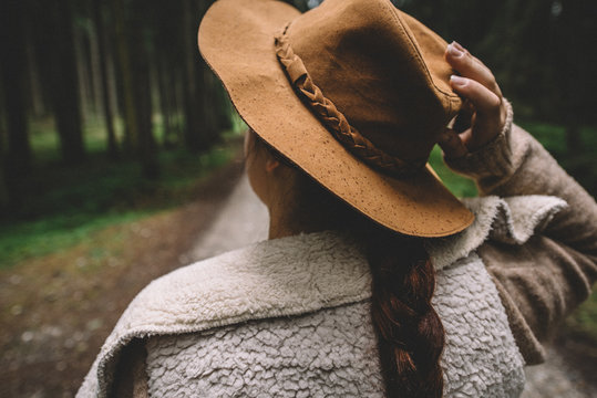 woman holding her hat