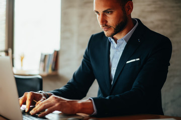 Businessman typing on laptop in the office