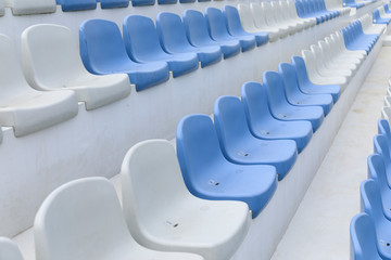 Empty stadium seats close up. Stadium chairs. Row after row of blue and white stadium seats.