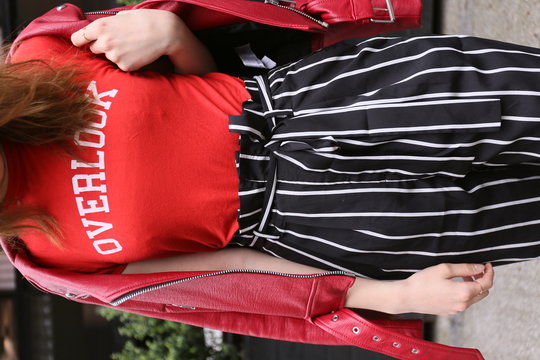 woman in red overlook-printer top and black and white striped bottoms