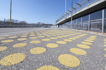 Yellow dots on wide pedestrian bridge
