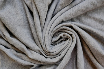 Grey clothes textile backdrop with spiral shape fabric.