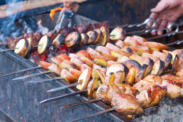 Shish kebab with potatos  roasting on the grill. BBQ party.