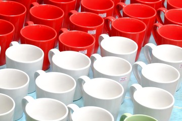 A pile of red white coffee mugs on the ground floor at the wholesale market 