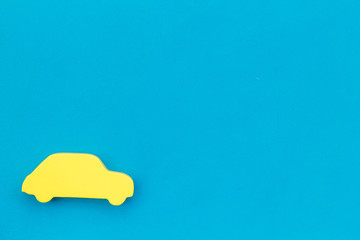 Car buying and insurance concept with car figure on blue background top view mock up