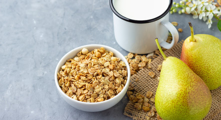Healthy eating or losing weight concept. Dry muesli (oat flakes) with fruit pear and milk.