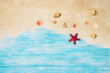 Top view of sandy beach and marine blue planks pier. Background with copy space and visible sand and wood texture.