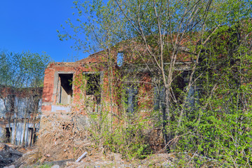 Old abandoned collapsing building. Landscape with the ruins of the old buildings.