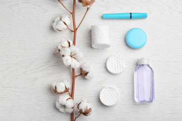 Flat lay composition with cotton pads on white wooden background