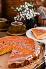 Cheesecake with chocolate and carrot puree. Vintage photo on wooden background.