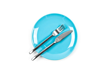 Set of empty blue plate, fork and knife on white background.
