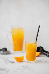 Refreshing orange lemonade. Poured into a glass and carafe