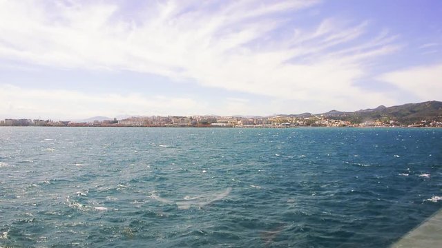 Ceuta, Spain View of the port in Ceuta enclave in North Africa seen from ferryboat approaching on blue Mediterranean sea after crossing the Gibraltar strait