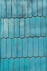 The plane of the wall paneling. Wooden texture. Old board. The peeling paint is blu.