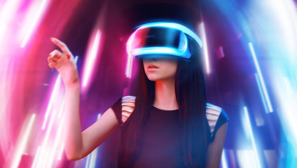 Model young woman in glasses of virtual reality. Augmented reality, science, future technology, people concept. VR. Futuristic 3d glasses with virtual projection. Neon light.