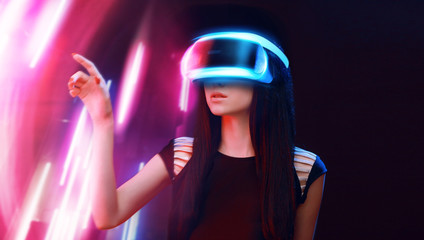 Model young woman in glasses of virtual reality. Augmented reality, science, future technology, people concept. VR. Futuristic 3d glasses with virtual projection. Neon light.