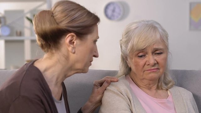 Old woman calming friend in time of trouble, relationship problems, divorce