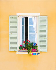 window with closed shutters on concrete wall