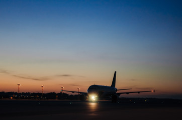 Fototapeta na wymiar big Aircraft in airport while sunrise