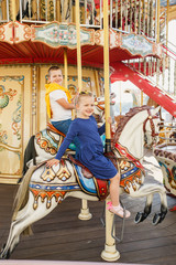 Fototapeta na wymiar little children brother and sister having fun on the carousel