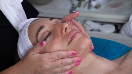 Caucasian woman enjoys a relaxing facial massage at a spa