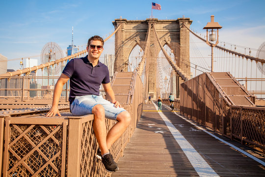 Tourist model posing for photo taking on a Brooklyn Bridge