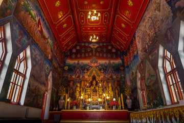 Fototapeta na wymiar Within the church of the Buddhist temple, there is a Buddha image for worship and a painting on the church wall.