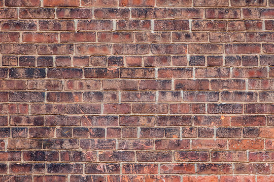 Empty old retro red brick wall background on sunny summer day in Brooklyn, New York, USA