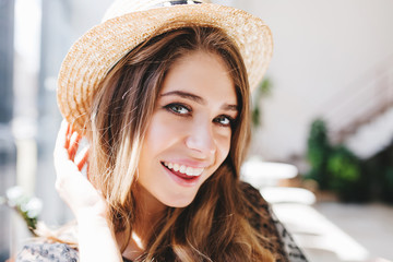 Close-up portrait of excited girl with pale skin and big gray eyes happy posing on blur background....