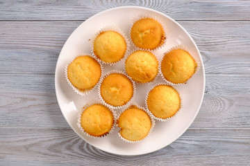 Lemon muffins with coffee on a white wooden table