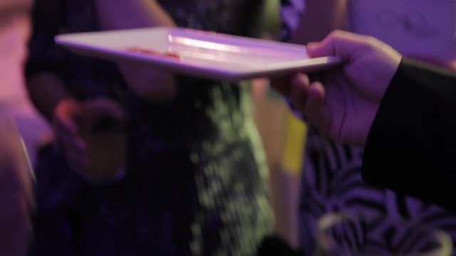People at a party eating ham