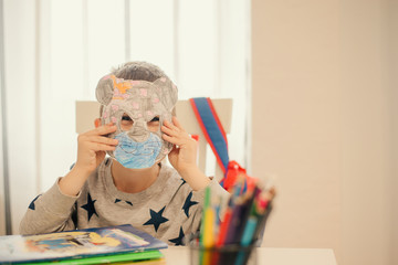 The little boy is doing homework.