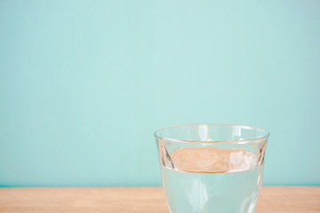 Glass of water on the table.  テーブルの上のグラス一杯の水