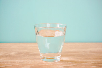 Glass of water on the table.  テーブルの上のグラス一杯の水