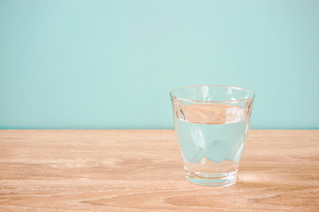 Glass of water on the table.  テーブルの上のグラス一杯の水