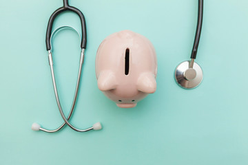 Medicine doctor equipment stethoscope or phonendoscope and piggy bank isolated on trendy pastel...