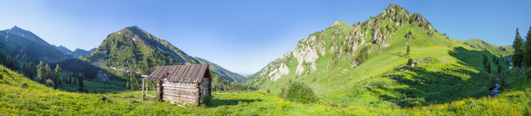 Hut in the mountains, shepherd's house. Summer panoramic view, Altai, Russia.