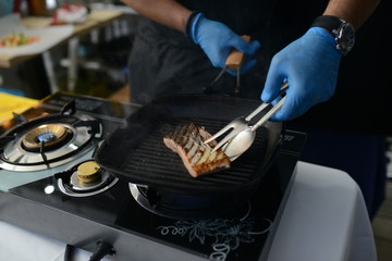 Making dinner at restaurant. Proffesional cooker