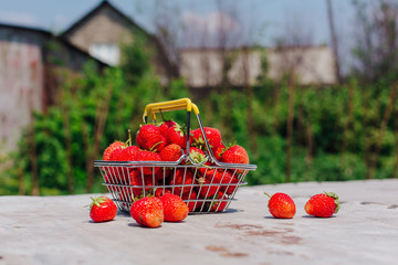 Mini shopping basket full of fresh red ripe strawberry on vintage background