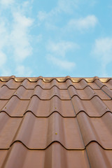 Roof house with tiled roof on blue sky