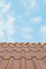 Roof house with tiled roof on blue sky