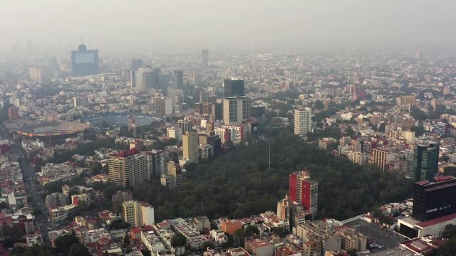 Aerial shot of Parque Hundido, Plaza de Toros, and soccer stadium in a very polluted day in Mexico City