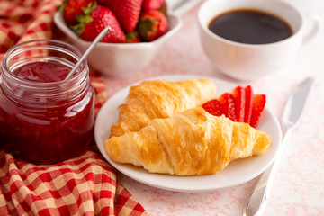 Table Set for Breakfast with Croissants Strawberries and Coffee