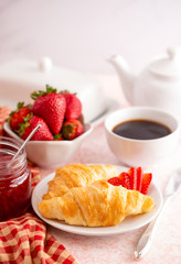 Table Set for Breakfast with Croissants Strawberries and Coffee