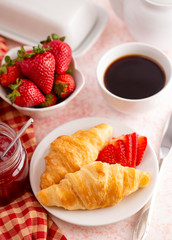 Table Set for Breakfast with Croissants Strawberries and Coffee
