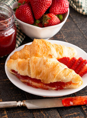 Croissants Filled with Fresh Homemade Strawberry Jam on Wooden Table