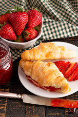 Croissants Filled with Fresh Homemade Strawberry Jam on Wooden Table