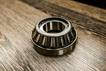 Car differential bearing on wooden background