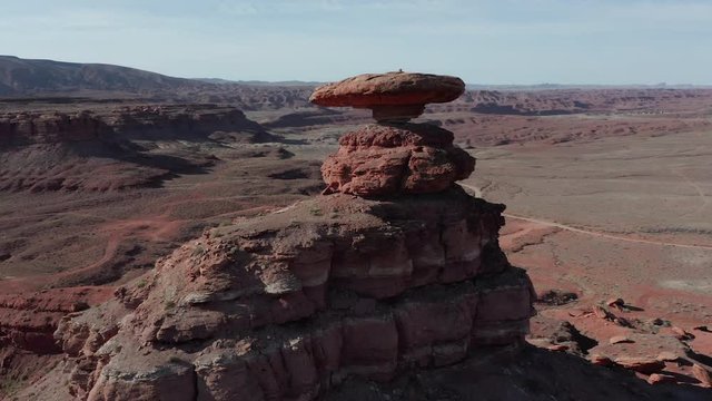 A wide, rotating shot of Mexican Hat Rock near Mexican Hat, Uth.